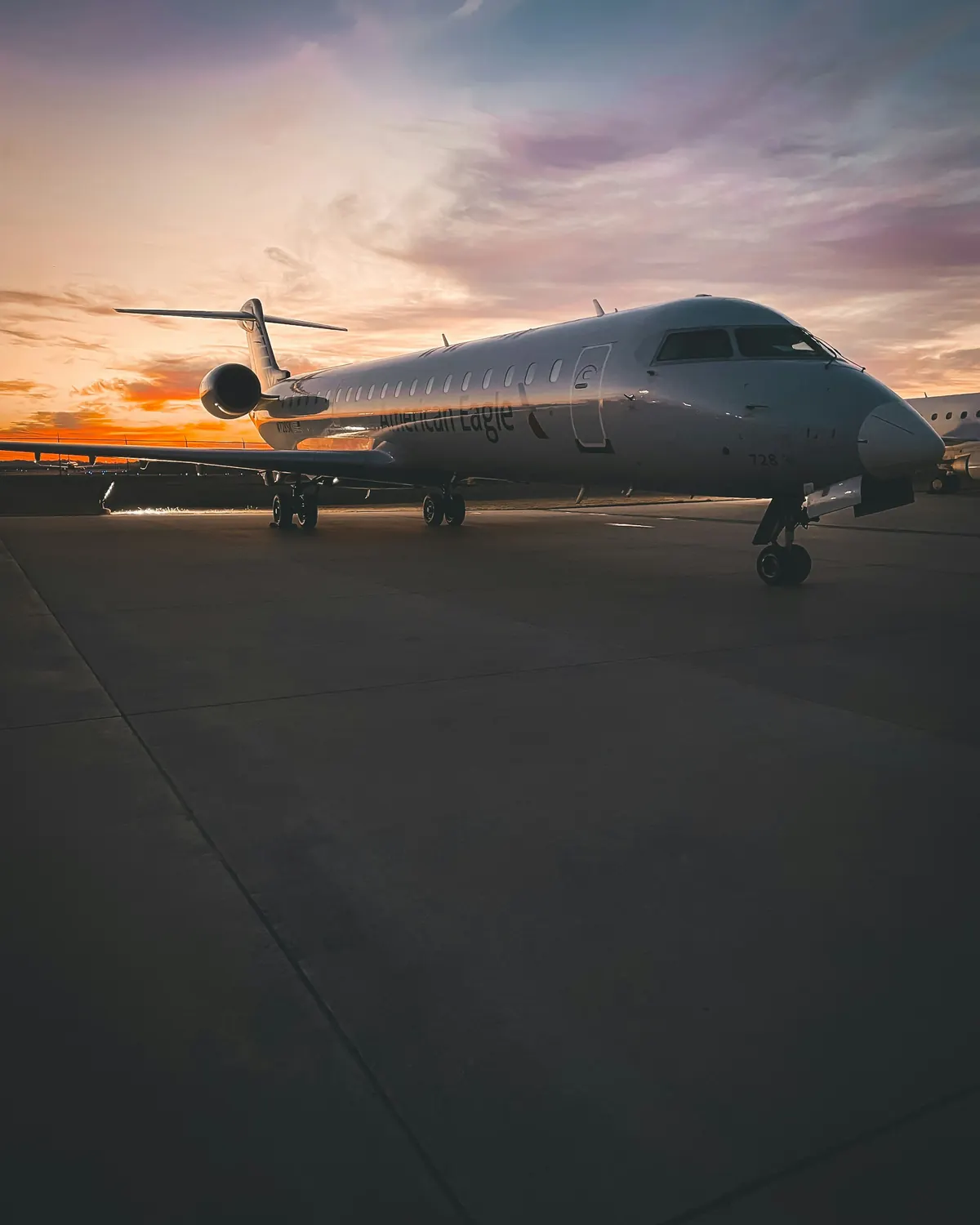 Business jet seen head-on on a ramp at dusk
