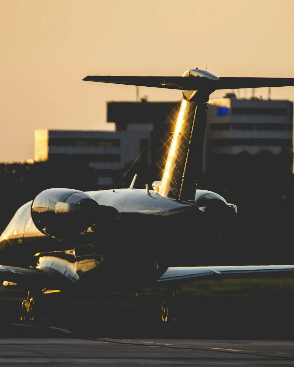 Long range business jet silhouetted on a ramp at night