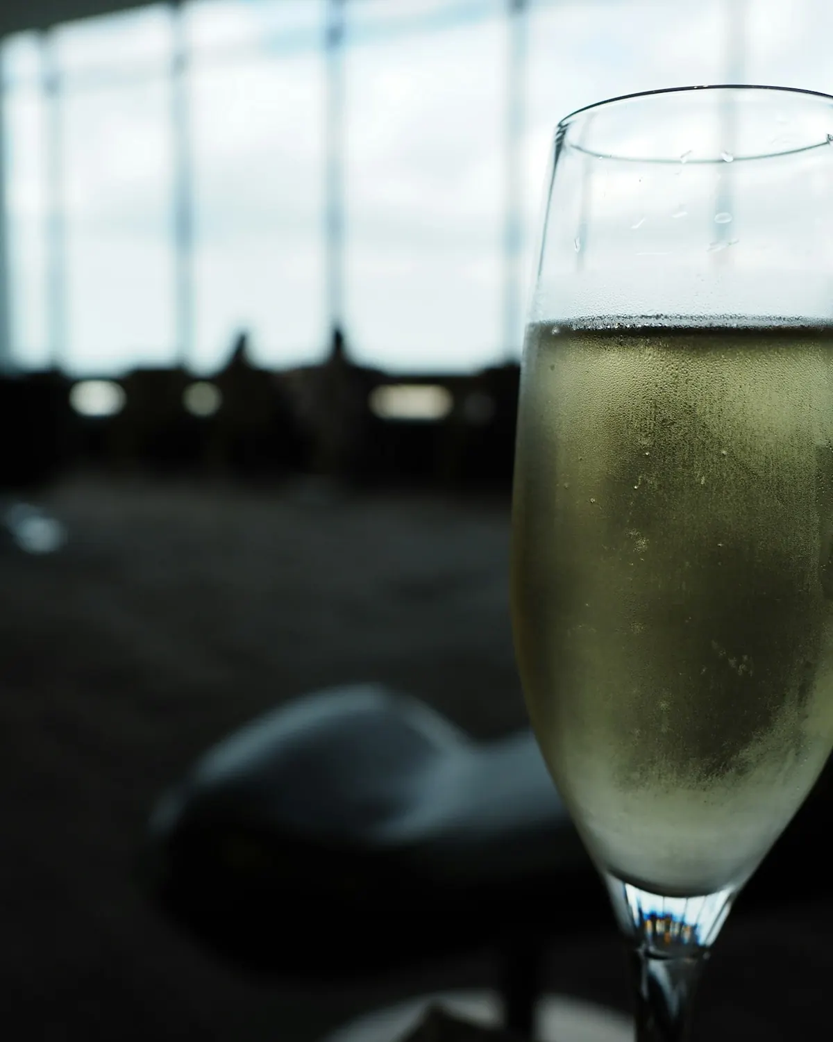 A glass of champagne by a window, the cabin softly out of focus