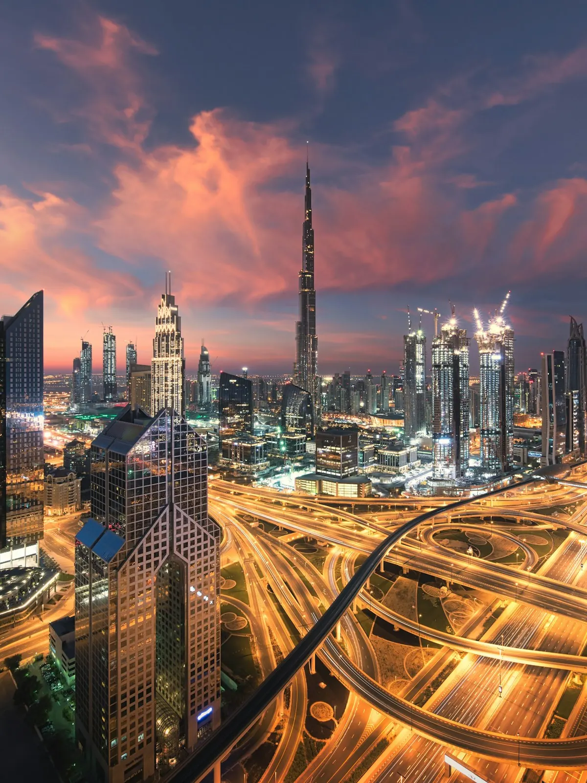 Dubai's towers and illuminated highway interchange at dusk